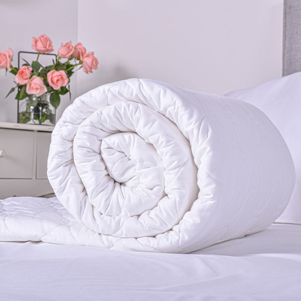 Eco-friendly pure cotton duvet rolled on the bed, ideal for natural and sustainable bedding